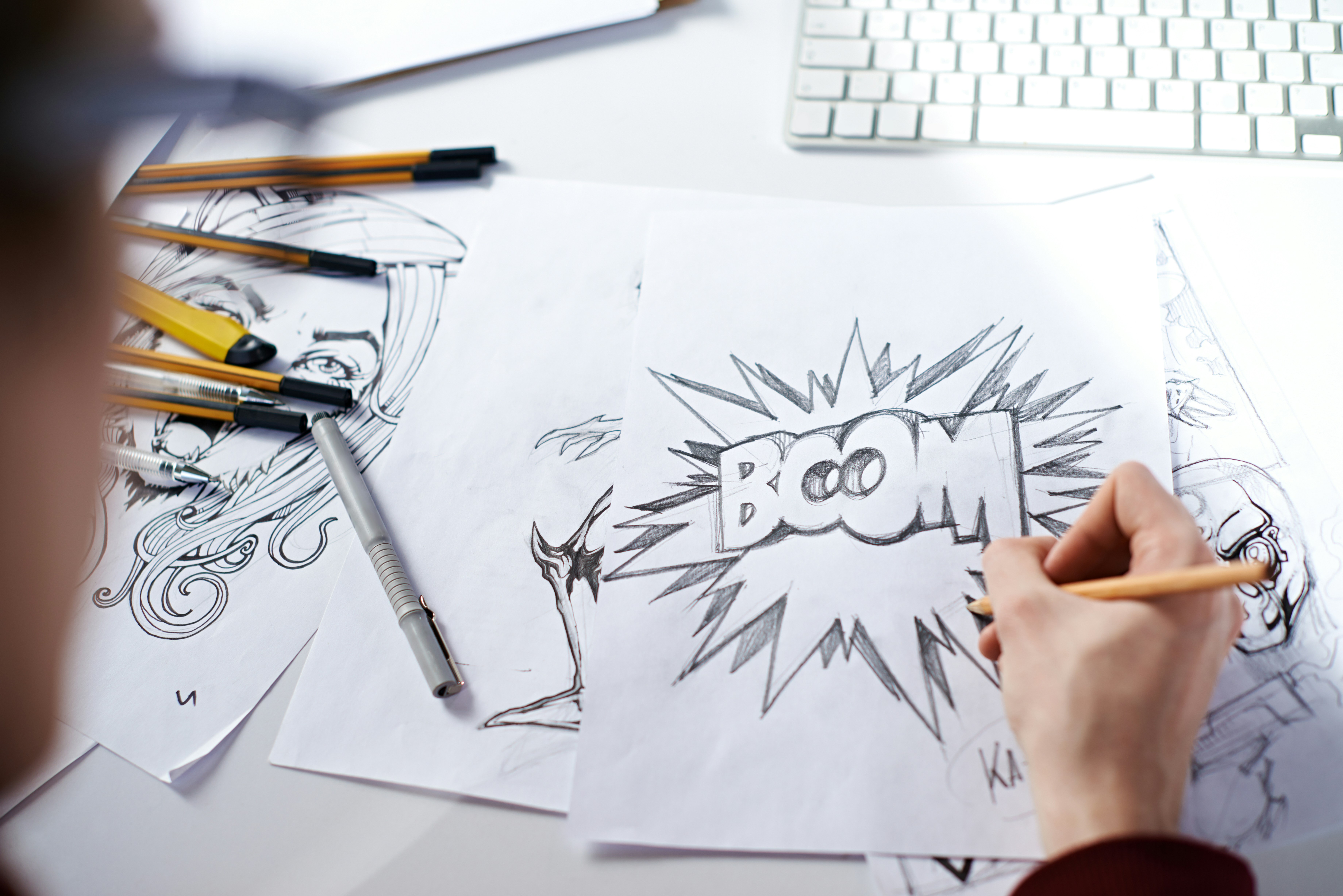 person drawing comic illustration