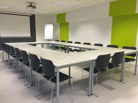 Green conference room table with chairs
