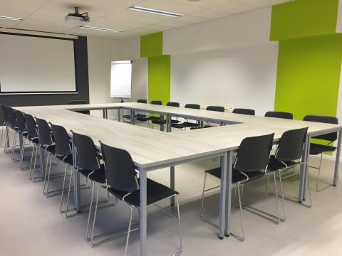 Green conference room table with chairs