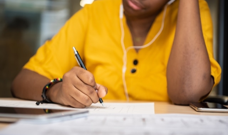 teen in yellow shirt studying